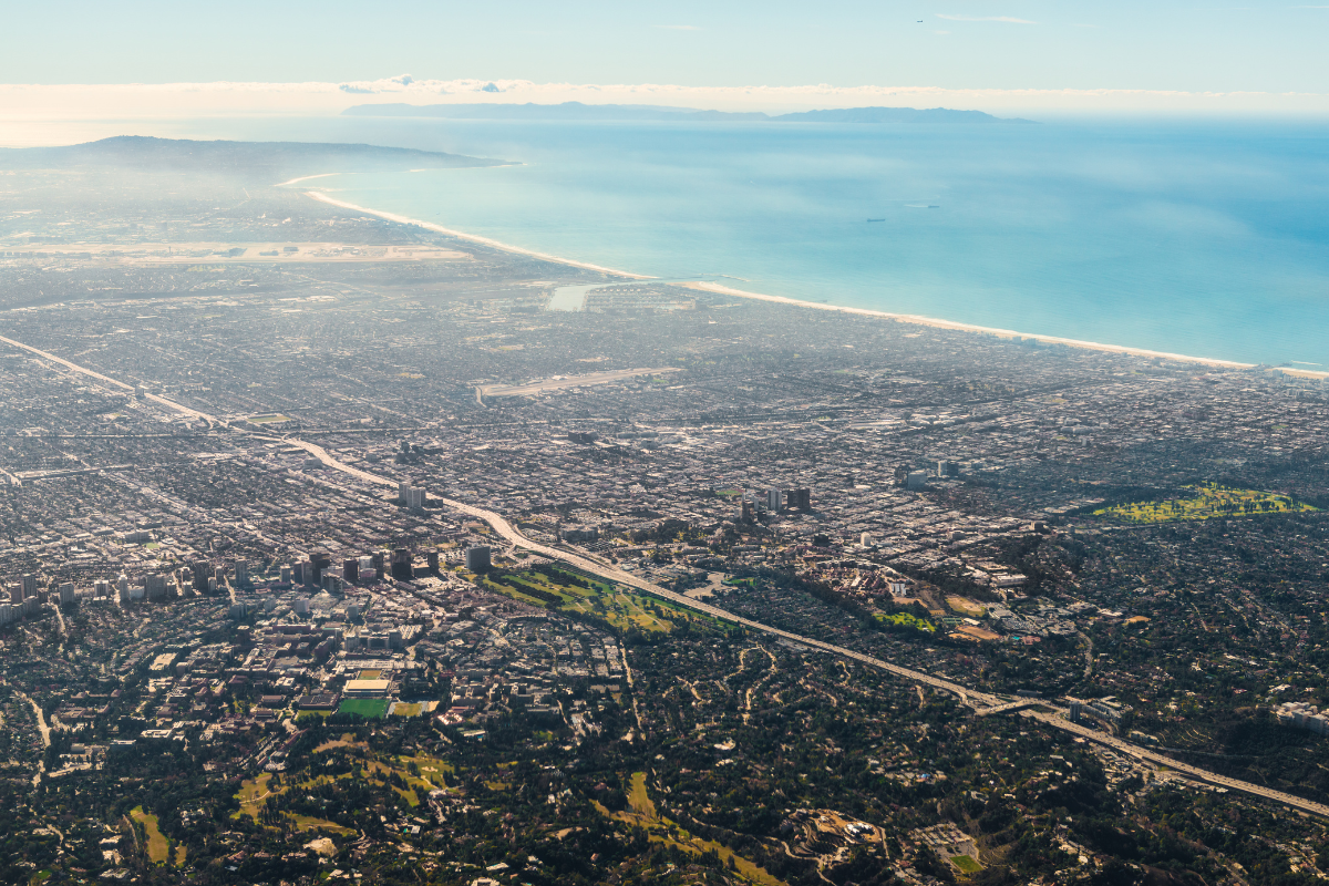 Aerial view of Los Angeles and the Southern California coastline, showing residential and commercial real estate across the Westside