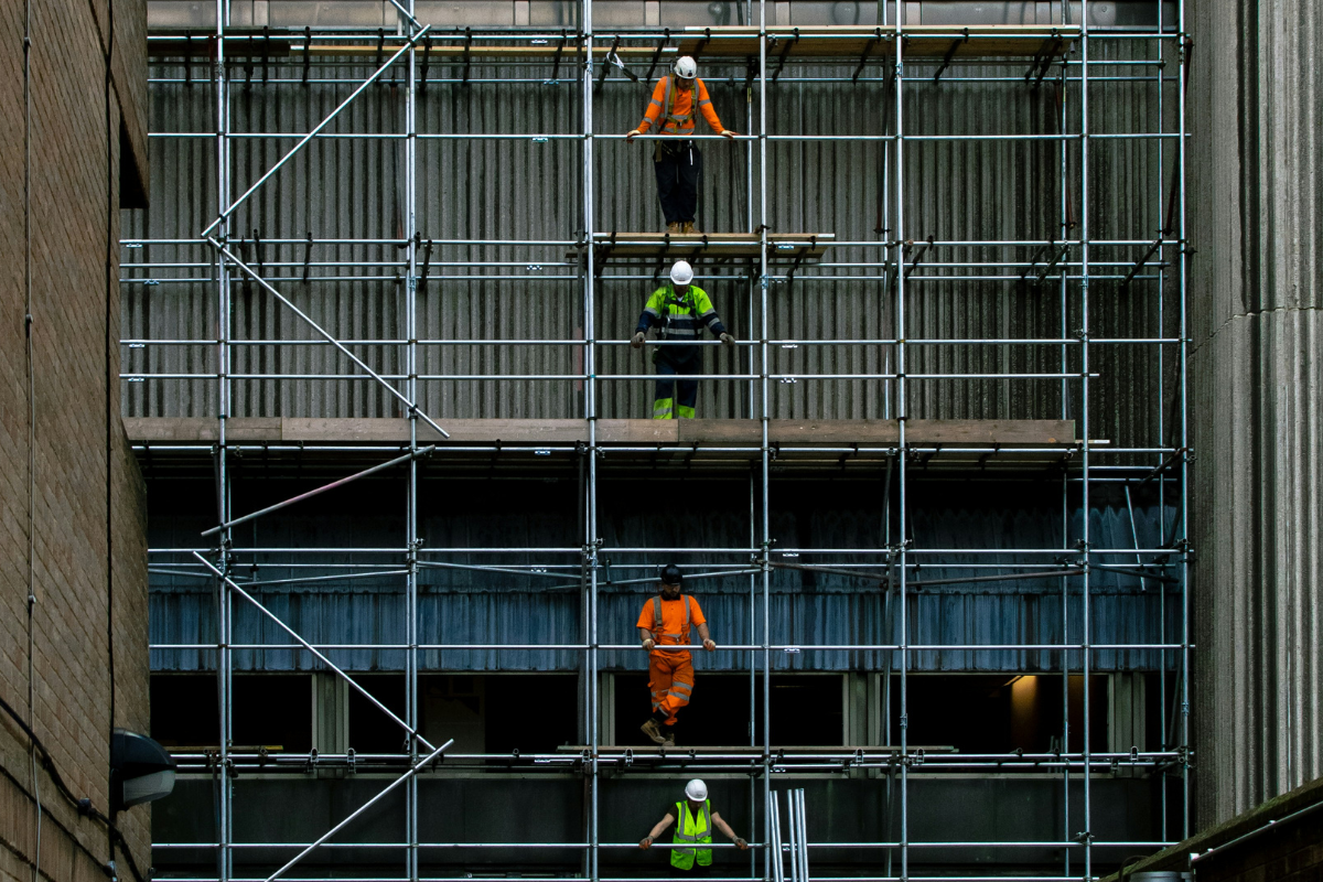 Workers on scaffolding renovating an existing commercial building